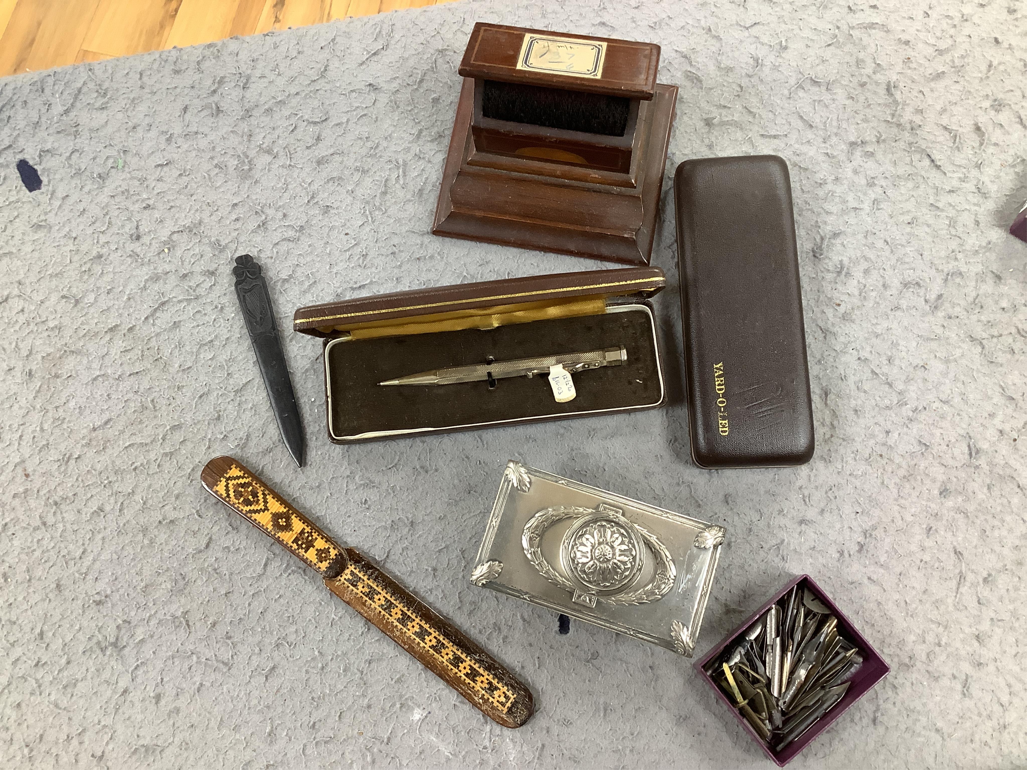 A collection of writing accessories including rulers, scientific rulers, paper knives, a Mauchline ware pencil case, pen nibs, etc. Condition - fair